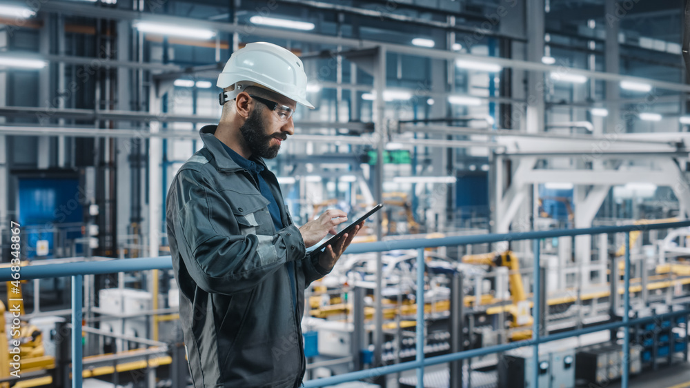 Aufkleber car factory engineer in work uniform using tablet computer. automotive industry 4.0 manufacturing fa