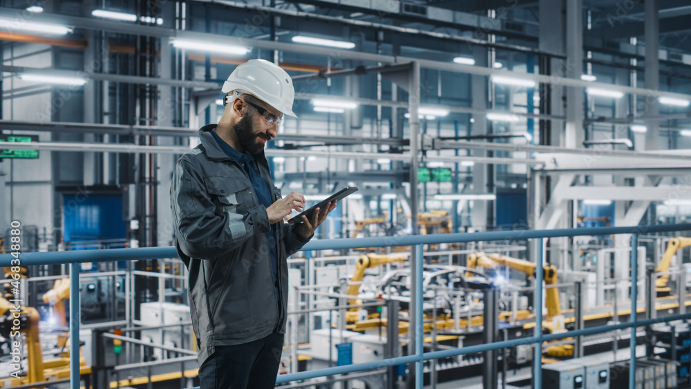 Poster car factory engineer in work uniform using tablet computer. automotive industry 4.0 manufacturing fa