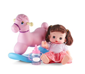 Doll is a girl, a brunette with her hair gathered in ponytails, sitting next to a rocking horse, isolated on a white background with a shadow.