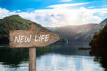 Start to live without alcohol addiction. Wooden signpost with inscription NEW LIFE against...