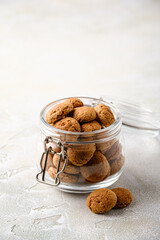 Kruidnoten cookies in glass jar. Pepernoten, traditional sweets, strooigoed. Dutch holiday Sinterklaas greetings card concept of Saint Nicholas day with copy space.