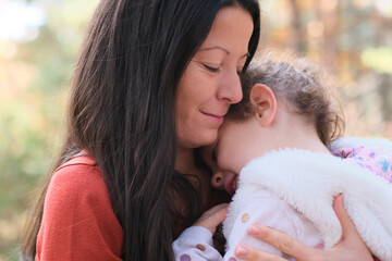 Mother and child in the forest exploring the nature having fun together smiling and laughing, true love emotion