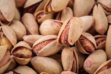 Closeup on scattered pistachios nuts in shell background texture