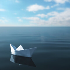 Obraz premium White paper boat floating on calm sea