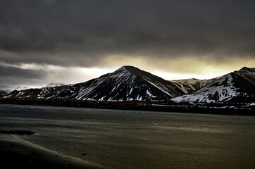 Akranes, iceland snow-capped mountain peaks and blue waters of the bay