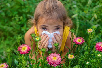 The child is seasonal allergy to flowers. Selective focus.