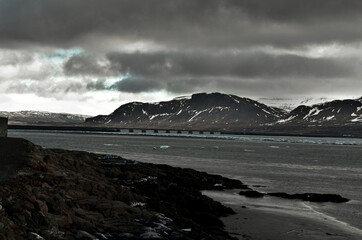 Akranes, iceland snow-capped mountain peaks and blue waters of the bay