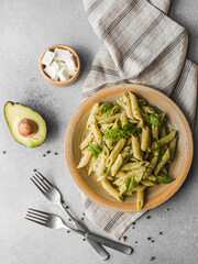 Pasta with pesto, avocado, goat cheese and basil