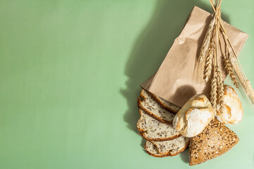 Assorted freshly baked bread with wheat ears, buns, and toasts