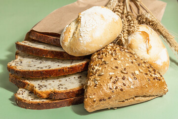 Assorted freshly baked bread with wheat ears, buns, and toasts