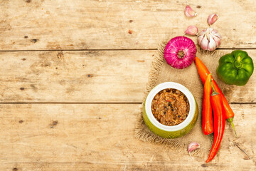 Vegan stew with a set of fresh vegetables. Chopped cooked ingredients on wooden background