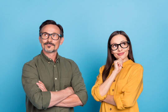 Photo of cheerful dreamy positive people look empty space think wear glasses isolated on blue color background
