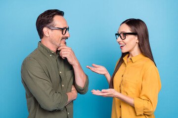 Photo of cheerful happy people partners talk smile conversation glasses isolated on blue color background