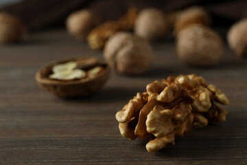Walnuts with kitchen towel on wooden background