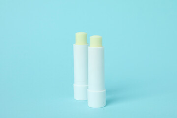 Eco lipstick on blue background, close up