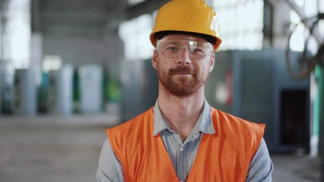Positive man engineer in uniform looking at the camera