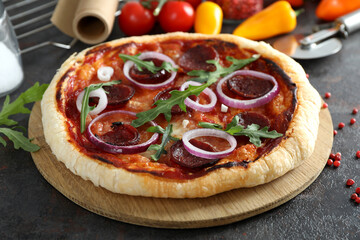 Concept of tasty food with Salami pizza on dark table