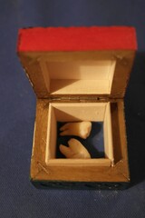 Dental concept: small wooden open box with two extracted wisdom teeth.