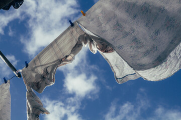 Clothes hanging on a sunny day with clouds in the background