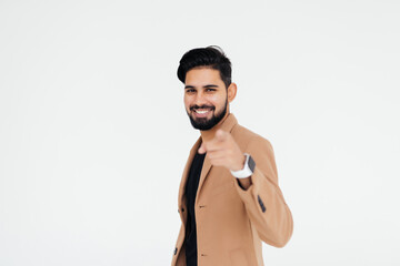 Confident indian business man pointing out towards you on white background with copyspace.