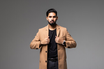 handsome businessman walking on light grey background