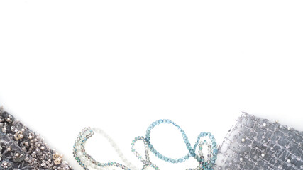 Top view of seamstress workplace with blue and dark blue tulle fabric, lace and beads. Sewing concept. Copy space. Selective focus. 