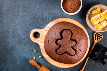 Christmas Baking background. Ingredients for cooking christmas baking on dark background. Top view with copy space. Gingerbread cookies. Baking Ginger cookies. Raw dought for cookies