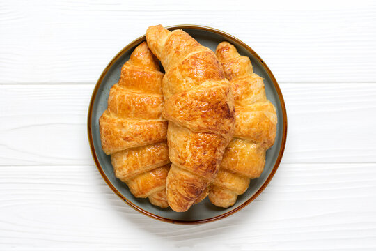 Fresh french croissants with chocolate on plate on white background Continental morning breakfast Top view Flat lay