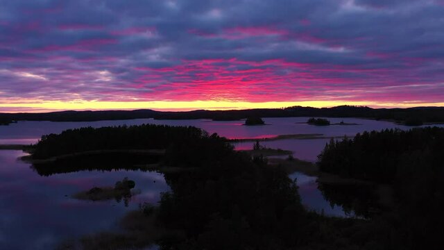 Stunning drone shot of colorful clouds and lake scape by the golden hour after sunset.
