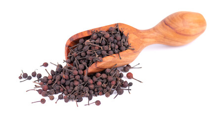 Bourbon pepper in wooden scoop, isolated on white background. Voatsiperifery or bourbonese piper....