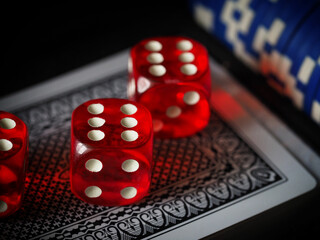 red playing dice, poker plastic chips, close-up, macrophotography, selective focus, blurry background, risk concept, stock exchange game, casino, gambling, gambling, excitement