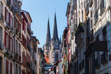 Street of a city in France with the cathedral towers in the background