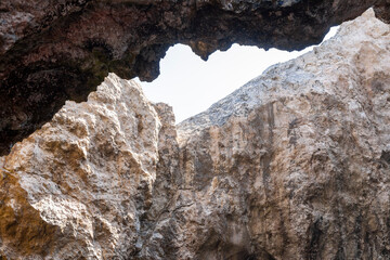 Fototapeta na wymiar Sunlight between the sea caves (bottom view), Tremiti Islands, Puglia, Italy