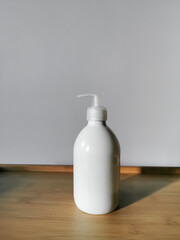 Body lotion in white dispenser bottle. For daily body care.