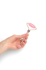 Jade roller facial massager in a female hand on a white background