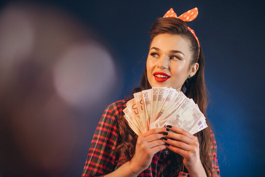Young pinup woman holding monye banknotes in her hands