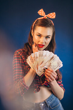 Young pinup woman holding monye banknotes in her hands