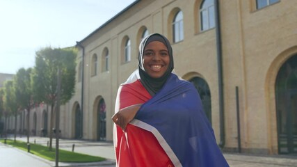 African muslim woman holding french flag, feeling proud of country, nationality