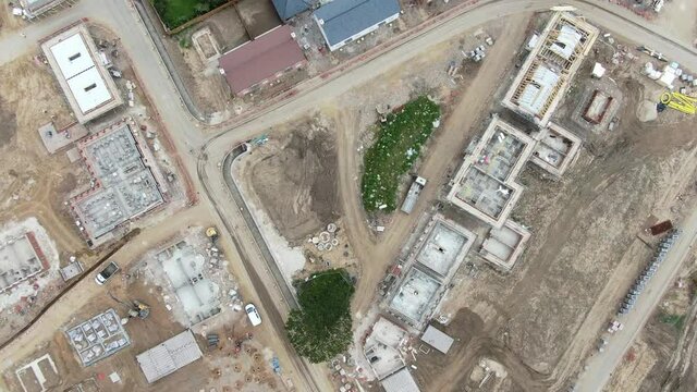 aerial video flying over housing construction site 