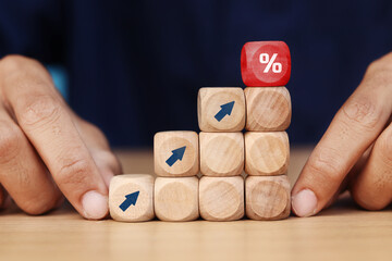 wooden cube block with arrow icon pointing towards percentage symbol icon, Finance and Mortgage...