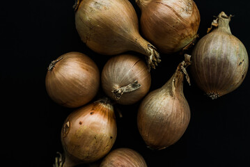 Raw yellow onion on the black background, Onion flat lay, vegetarian fresh, close up photo 