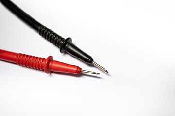 Anode and cathode multimeter on a white background black and red multimeter probes