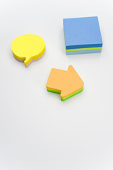 blank and colorful sticky note sheets on a white background with copy space