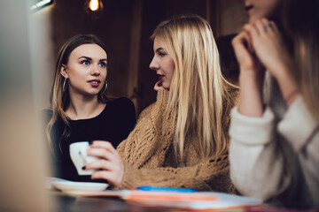 Trendy young women enjoying time in cafe