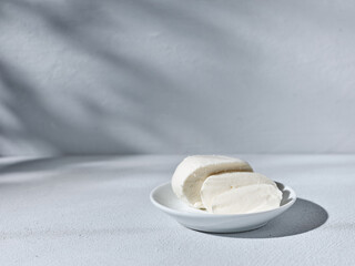 Sliced homemade mozzarella cheese on the kitchen table
