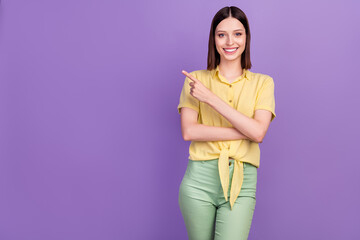 Photo of young pretty girl indicate finger empty space ads promo decision isolated over violet color background
