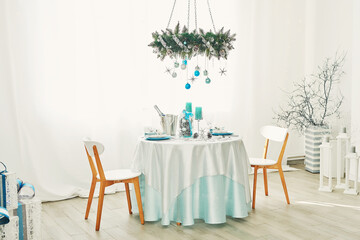 Christmas table. Blue and white decor christmas tree background. New Year celebration. Merry Christmas and Happy New Year.