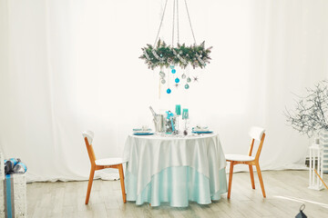 Christmas table. Blue and white decor christmas tree background. New Year celebration. Merry Christmas and Happy New Year.