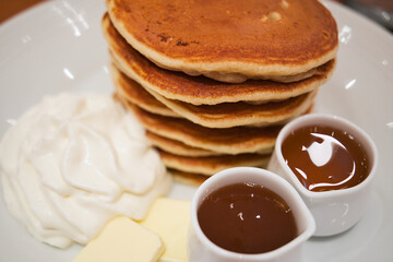 ホイップとシロップが添えられたパンケーキ