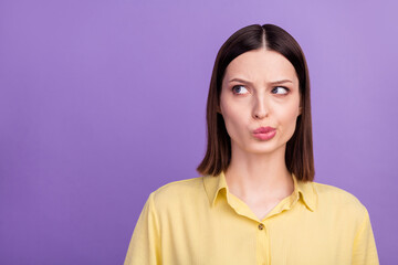 Photo of young charming lady unhappy negative look empty space thoughts isolated over violet color background